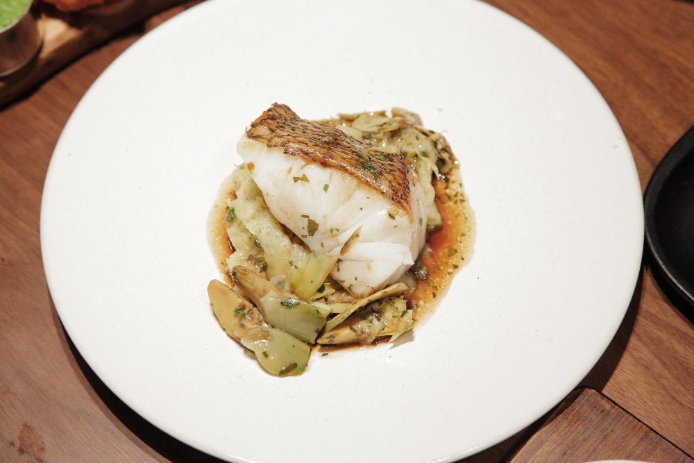 Roasted black cod with crushed potatoes, salted capers, artichoke, red wine and lemon sauce