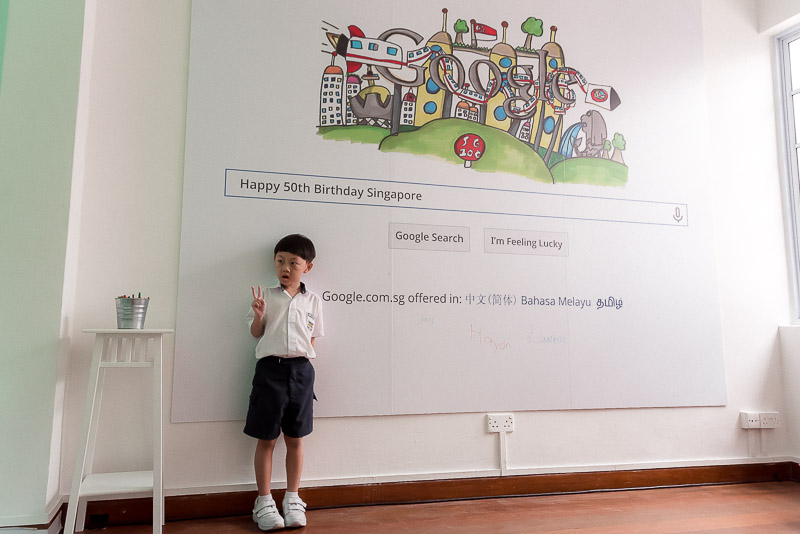 Jayden with an enlarged print of his doodle.