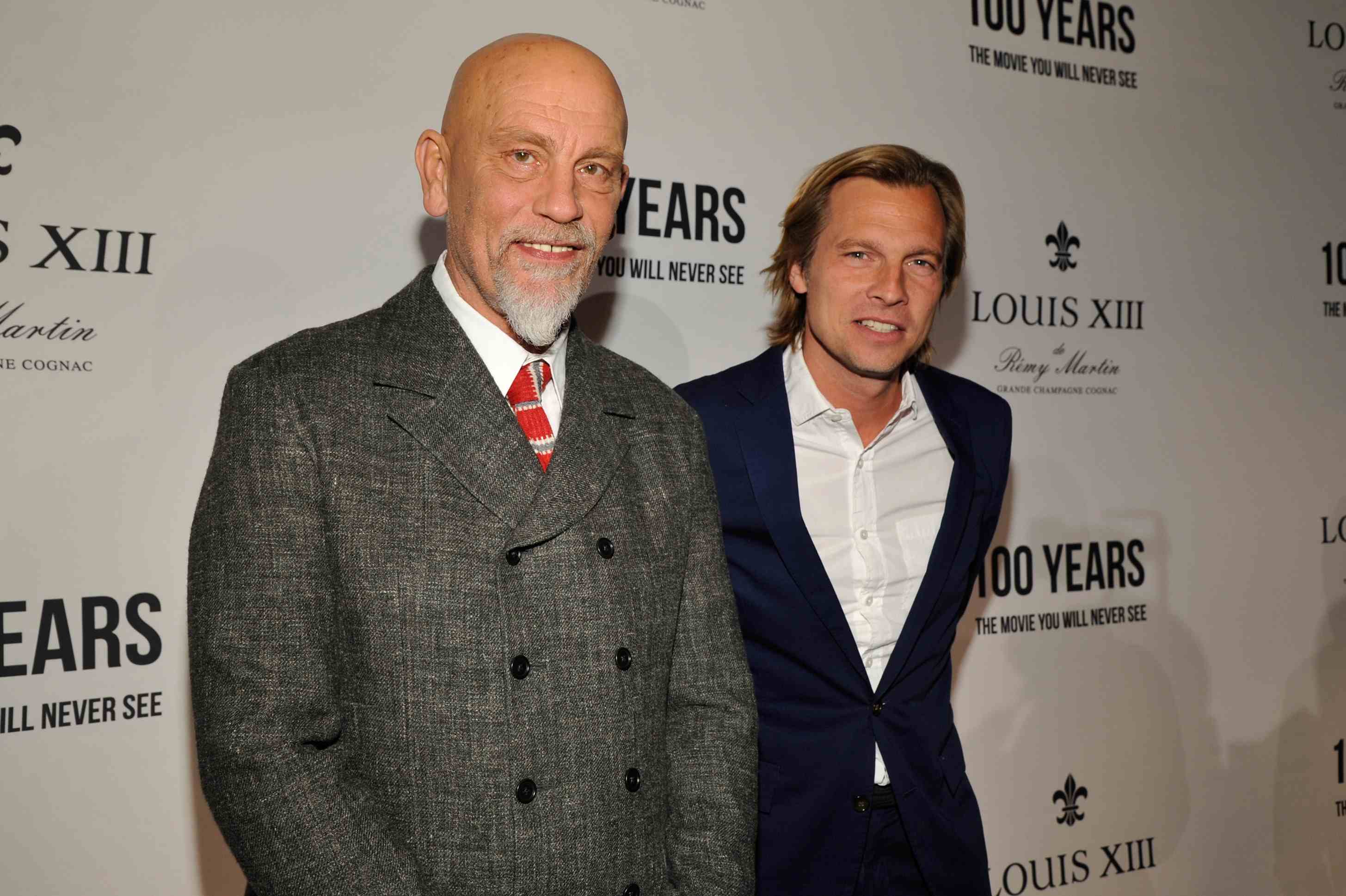 BEVERLY HILLS, CA - NOVEMBER 18: Actor John Malkovich (L) and Louis XIII Global Executive Director Ludovic du Plessis attend Louis XIII Celebration of "100 Years" The Movie You Will Never See, starring John Malkovich at a private residence on November 18, 2015 in Beverly Hills, California. (Photo by John Sciulli/Getty Images for Louis XIII)