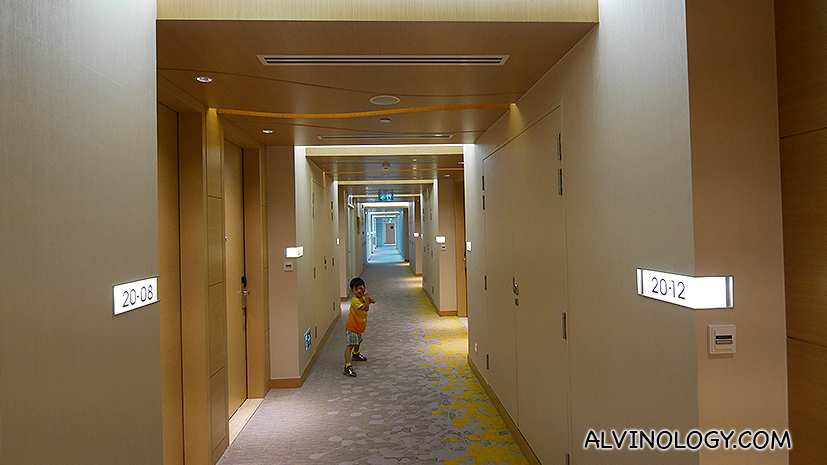 Asher running around in the brightly lit corridor 