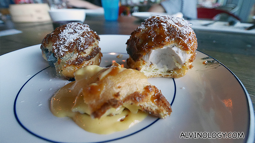 The puffs are filled with Salted Egg Yolk crème patisserie, whipped Orh Nee paste or Black Sesame soy milk bavarian cream. Served with a drizzling of coconut caramel and desiccated coconut.